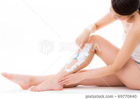 A woman shaving a razor. A woman shaving a razor. 69770640