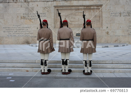 Evzones, the honorary Greek Presidentiial Guard, at the Tomb of the Unknown Soldier. Center of Athens Greece, Syntagma Square. 69770813