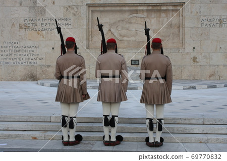 Evzones, the honorary Greek Presidentiial Guard, at the Tomb of the Unknown Soldier. Center of Athens Greece, Syntagma Square. Evzones, the honorary Greek Presidentiial Guard, at the Tomb of the Unknown Soldier. Center of Athens Greece, Syntagma Square. 69770832