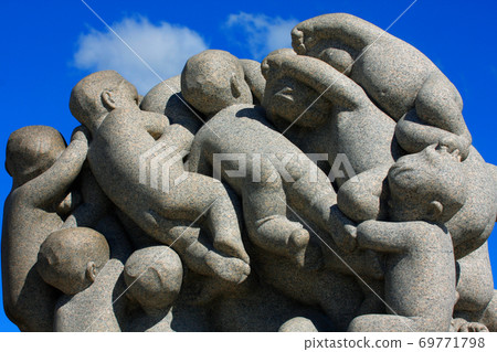 Statue of man and children by Gustav Vigeland in Oslo, Norway. 69771798
