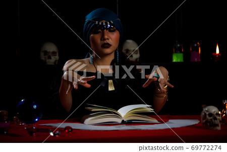 Fortune teller use horoscope book to forecast fate or destiny of people. Fortune teller use horoscope book to forecast fate or destiny of people. 69772274