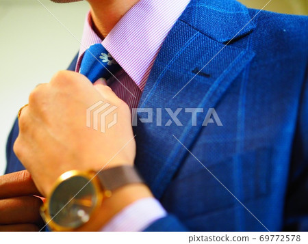 Male tying a tie Male tying a tie 69772578