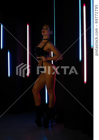 Female stripper against neon lights Female stripper against neon lights 69772795