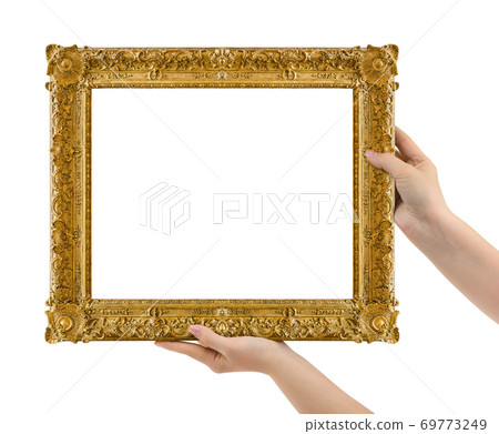 Wooden picture frame in hands Wooden picture frame in hands 69773249
