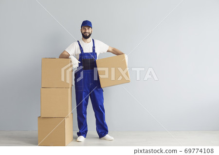 Happy delivery man with boxes Happy delivery man with boxes 69774108