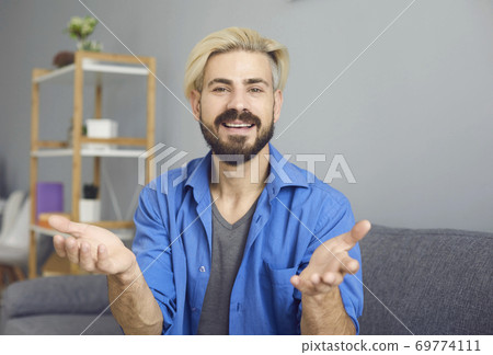 Guy looking at the camera online talks at a meeting training education video chat webinar call application. Guy looking at the camera online talks at a meeting training education video chat webinar call application. 69774111