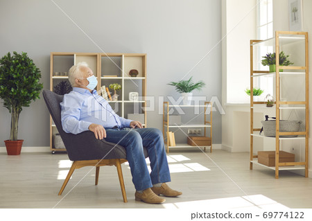 Elderly man, as risk group member, staying at home and not going outside caring about his health Elderly man, as risk group member, staying at home and not going outside caring about his health 69774122