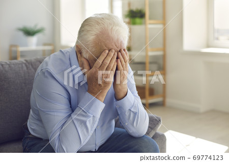 Elderly man, grieving about death of relative or forgotten by family, crying alone Elderly man, grieving about death of relative or forgotten by family, crying alone 69774123