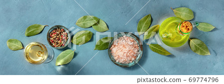 Cooking panorama. A flat lay with salt, pepper, bay leaves, olive oil, and white wine, overhead shot Cooking panorama. A flat lay with salt, pepper, bay leaves, olive oil, and white wine, overhead shot 69774796
