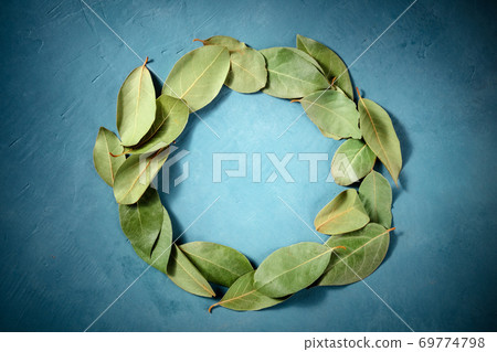 Culinary frame with a place for text. A wreath of bay leaves, shot from the top 69774798