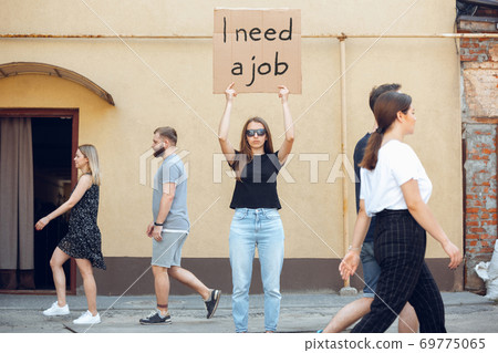 Dude with sign - woman stands protesting things that annoy him Dude with sign - woman stands protesting things that annoy him 69775065