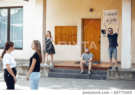 Dude with sign - man stands protesting things that annoy him 69775069