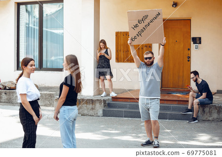 Dude with sign - man stands protesting things that annoy him 69775081