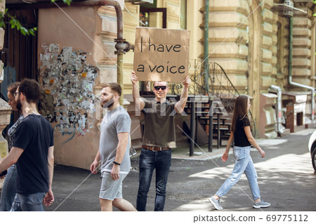 Dude with sign - man stands protesting things that annoy him 69775112