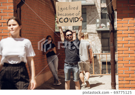 Dude with sign - man stands protesting things that annoy him 69775125