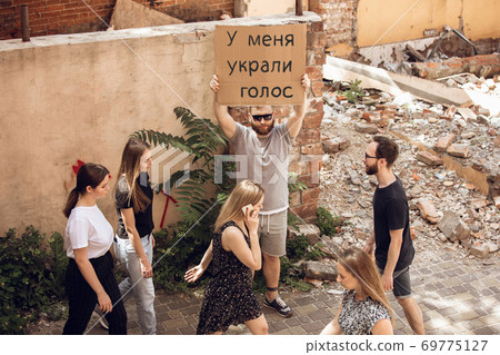 Dude with sign - man stands protesting things that annoy him 69775127