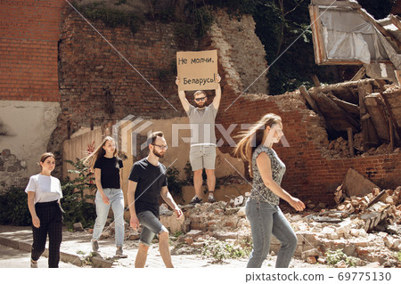 Dude with sign - man stands protesting things that annoy him 69775130