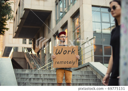 Dude with sign - man stands protesting things that annoy him 69775131