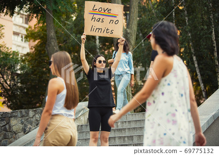 Dude with sign - woman stands protesting things that annoy him 69775132