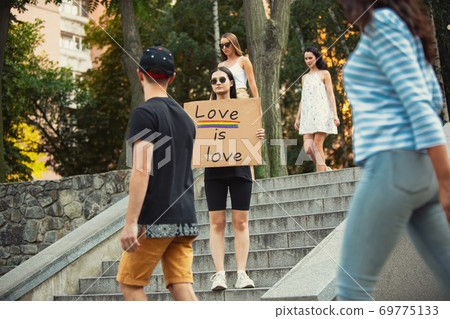 Dude with sign - woman stands protesting things that annoy him 69775133
