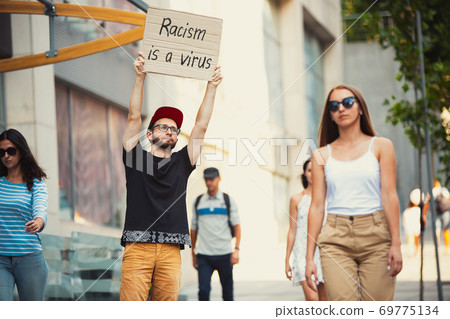 Dude with sign - man stands protesting things that annoy him 69775134