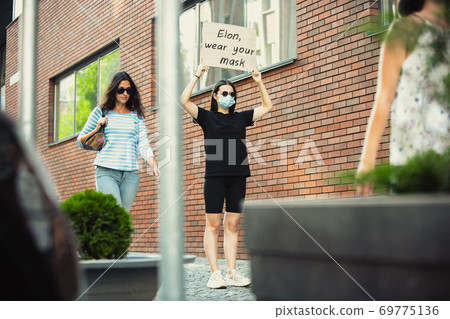 Dude with sign - woman stands protesting things that annoy him 69775136