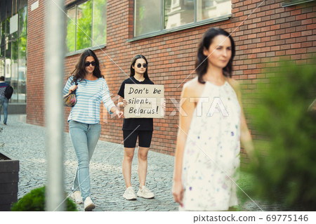 Dude with sign - woman stands protesting things that annoy him 69775146