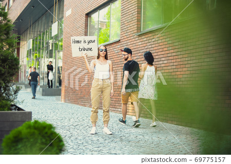 Dude with sign - woman stands protesting things that annoy him 69775157