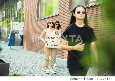 Dude with sign - woman stands protesting things that annoy him 69775158