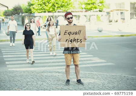 Dude with sign - man stands protesting things that annoy him 69775159