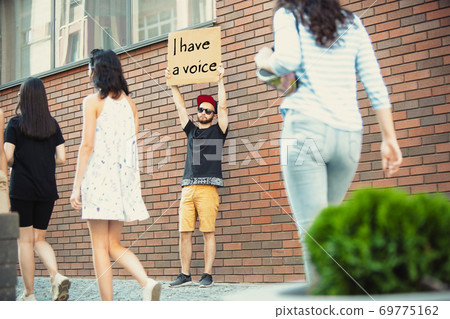 Dude with sign - man stands protesting things that annoy him 69775162