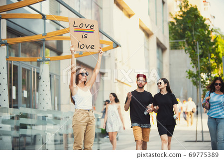Dude with sign - woman stands protesting things that annoy him 69775389