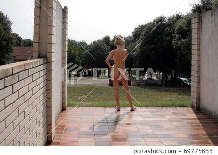 Naked woman on the nudist beach Naked woman on the nudist beach 69775633