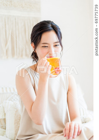 坐在床和微笑上的婦女 69775739