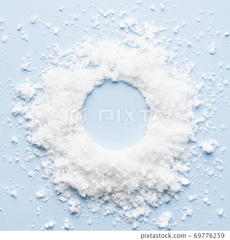 Wreath made of snow on blue background. 69776259