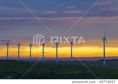 Wind Turbines in field against sunset sky, Spain 69778697