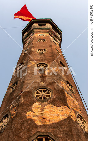 Tower with fluttering national flag at Hanoi know as The Flag Tower of Hanoi, Vietnam. Tower with fluttering national flag at Hanoi know as The Flag Tower of Hanoi, Vietnam. 69780260