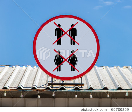 A circle board with pictogram A ban on entry by same-sex partners.  69780269