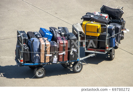 Luggage loaded on cart on a airport. Suitcases of passengers on a trolley ready for transport. 69780272