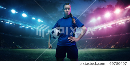 Football or soccer player on full stadium and flashlights background Football or soccer player on full stadium and flashlights background 69780497