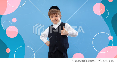 Jewish boy portrait isolated on bright, modern illustrated background. 69780540