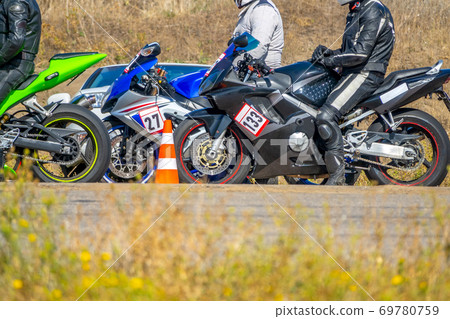 Athletes Motorcyclists Waiting for the Start Athletes Motorcyclists Waiting for the Start 69780759