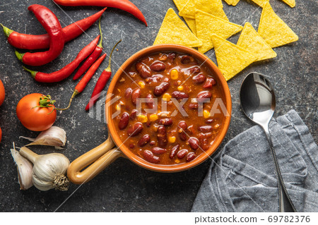 Chili con carne. Mexican food with beans in pot Chili con carne. Mexican food with beans in pot 69782376