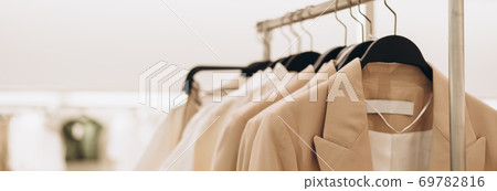 Banner for women's clothing store in beige colors. Selective focus, copy space 69782816