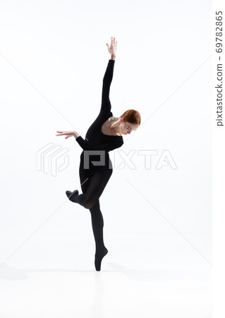 Young and graceful ballet dancer in minimal black style isolated on white studio background Young and graceful ballet dancer in minimal black style isolated on white studio background 69782865
