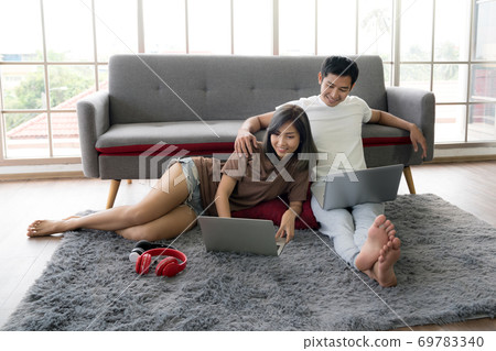 Asian couple business persons using laptop computers and working from home 69783340