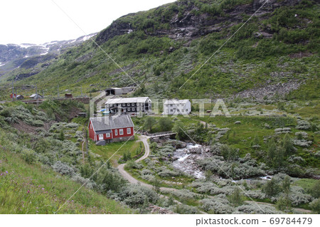 View of the valley side houses and trekking course from Myrdal station on the Norwegian railway Bergen line View of the valley side houses and trekking course from Myrdal station on the Norwegian railway Bergen line 69784479