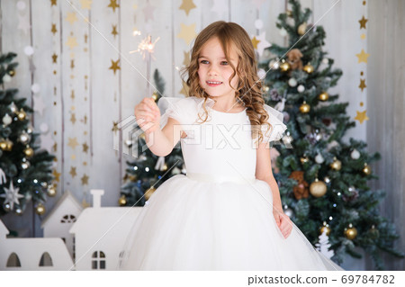 girl girl with sparklers near Christmas tree girl girl with sparklers near Christmas tree 69784782