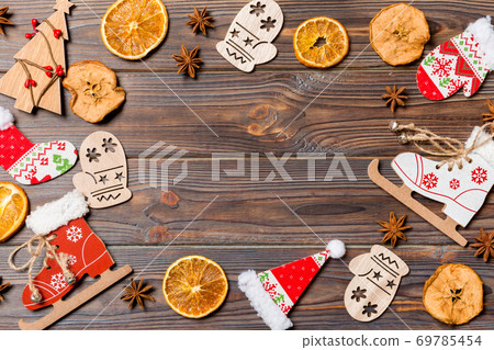 Top view of Christmas decorations and toys on wooden background. Copy space. Empty place for your design. New Year concept Top view of Christmas decorations and toys on wooden background. Copy space. Empty place for your design. New Year concept 69785454