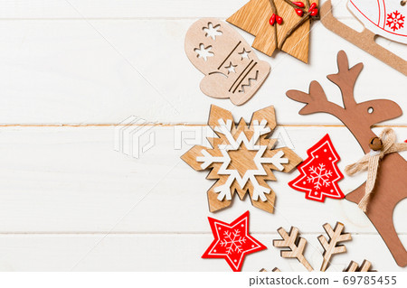 Top view of Christmas decorations and toys on wooden background. Copy space. Empty place for your design. New Year concept Top view of Christmas decorations and toys on wooden background. Copy space. Empty place for your design. New Year concept 69785455